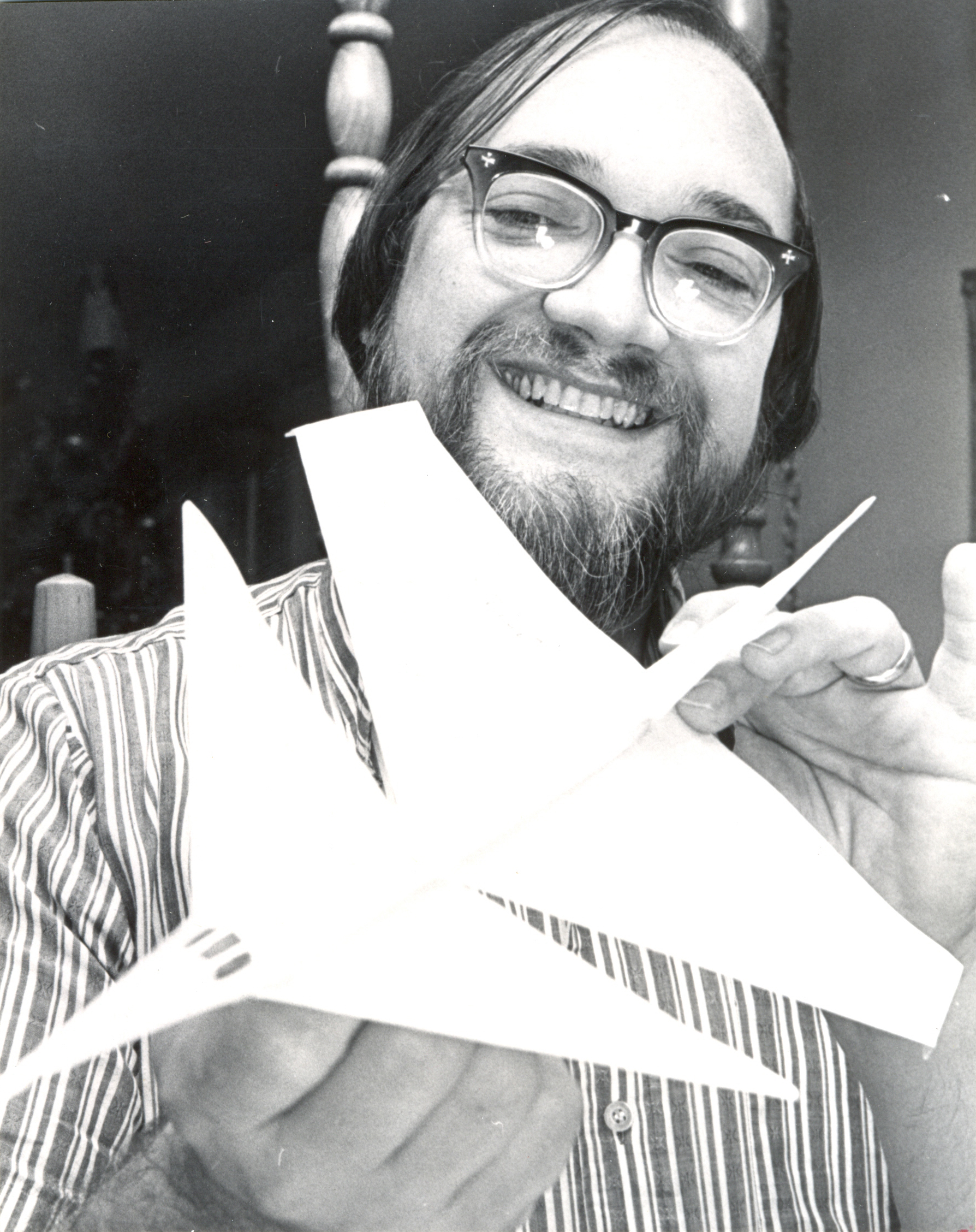 Frank H. Scott with one of the designs he plans to enter in the paper airplane contest at the Convention Center. Photo by Roberts. Dec. 1975. (Dayton Daily News Archive, DDNBW, Airplanes-paper-contests)