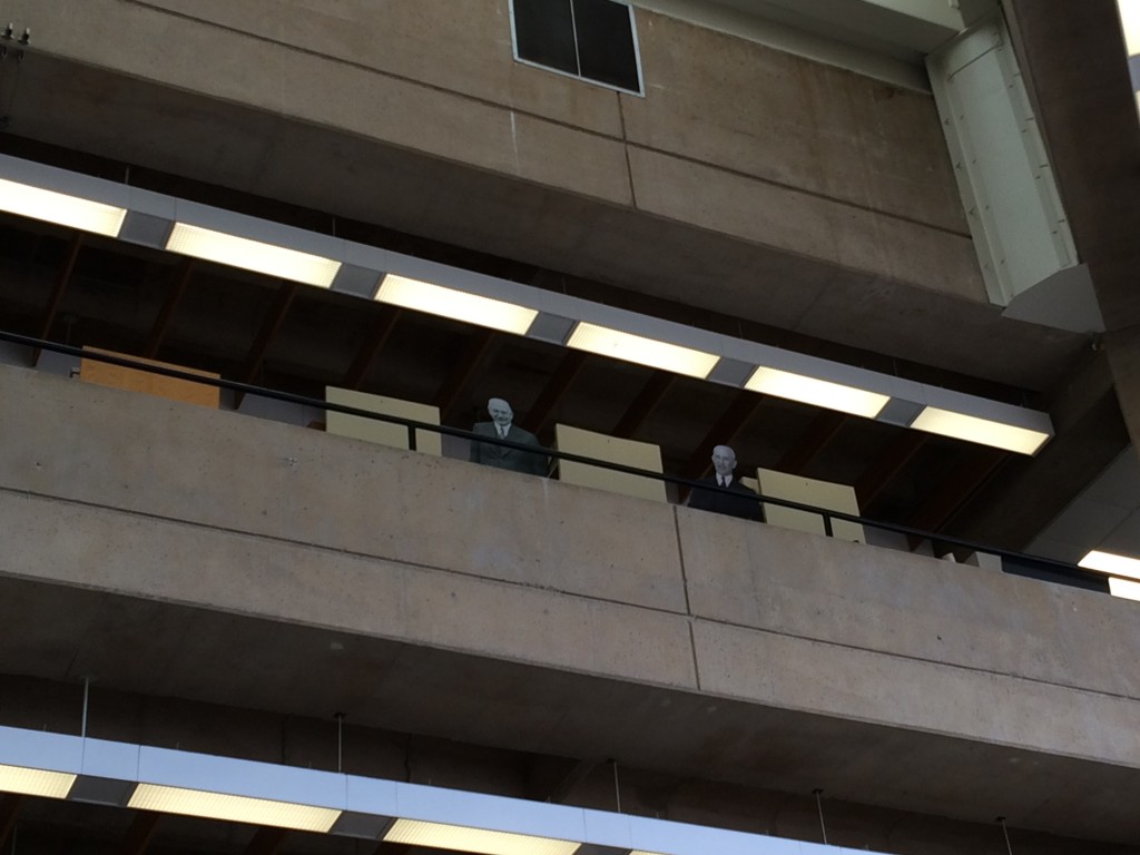 Life-size cutouts of Deeds and Wright on the Dunbar Library's fourth floor balcony.