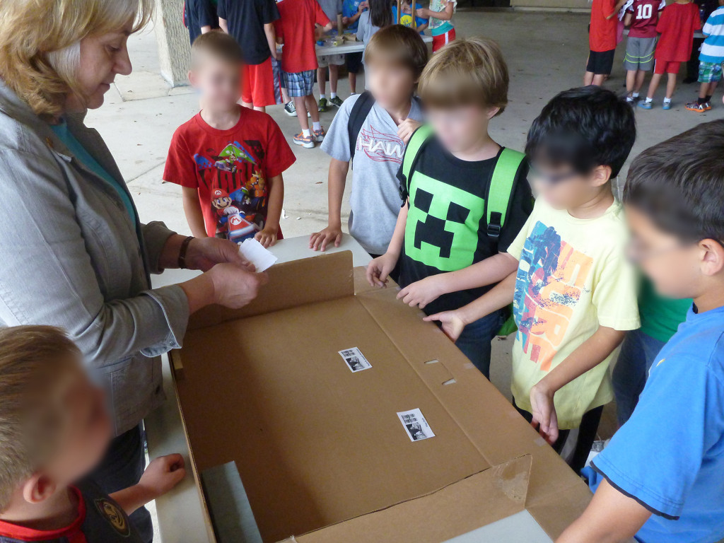 Dawne Dewey leads children in a History to Go activity, July 28, 2014