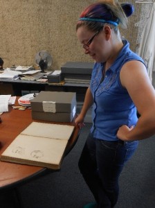 Karis Raeburn discovers original drawings of two men in the back of a Strayer General Store ledger while cleaning.