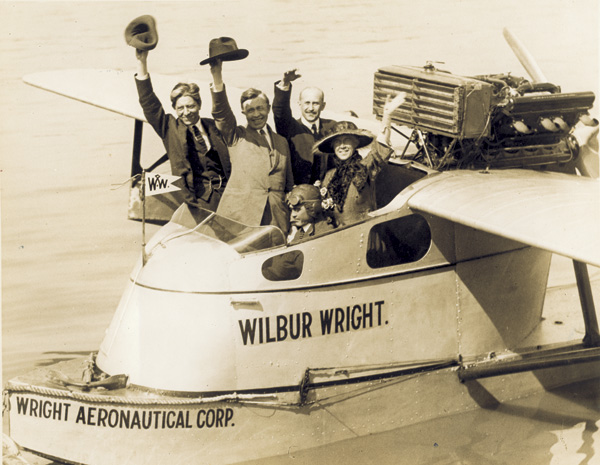 Percy Mackaye, Vilhjalmur Stefansson, and Orville and Katharine Wright wave at the camera from the Wright Aeronautical Corporation flying boat the "Wilbur Wright," 1922. (photo ms1_23_13_2)