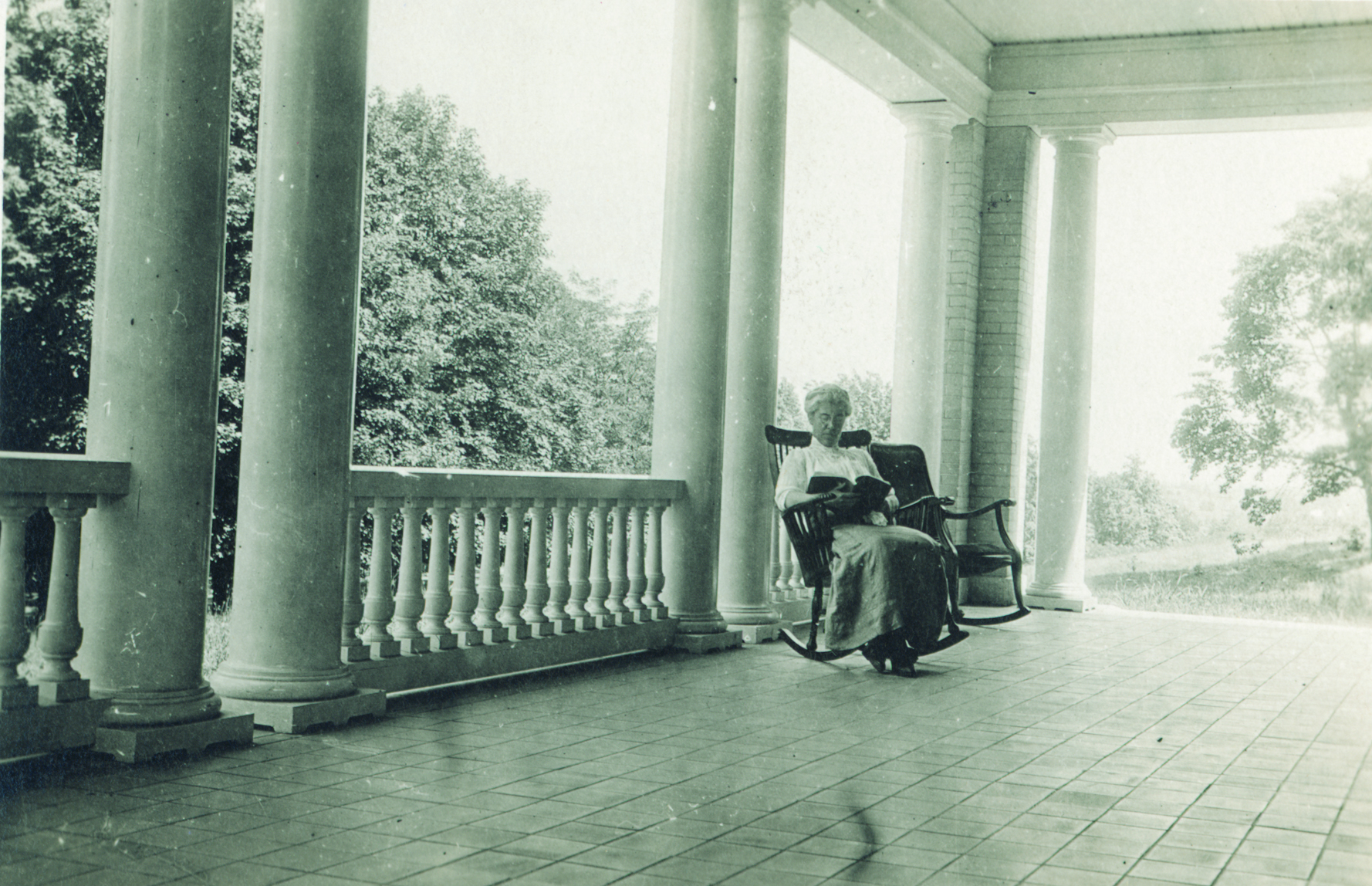 Katharine Wright reading on porch of Hawthorn Hill home in Oakwood, 1920 (photo ms1_26-5-4)