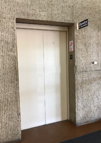 Photo of single elevator just inside of library entrance nearest Tom Hanks Center