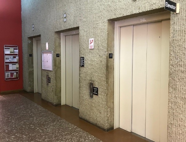 Photo of three elevators across from Circulation Desk