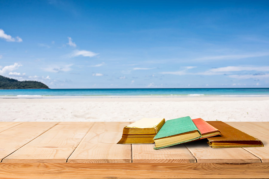 image of books on bench at the beach