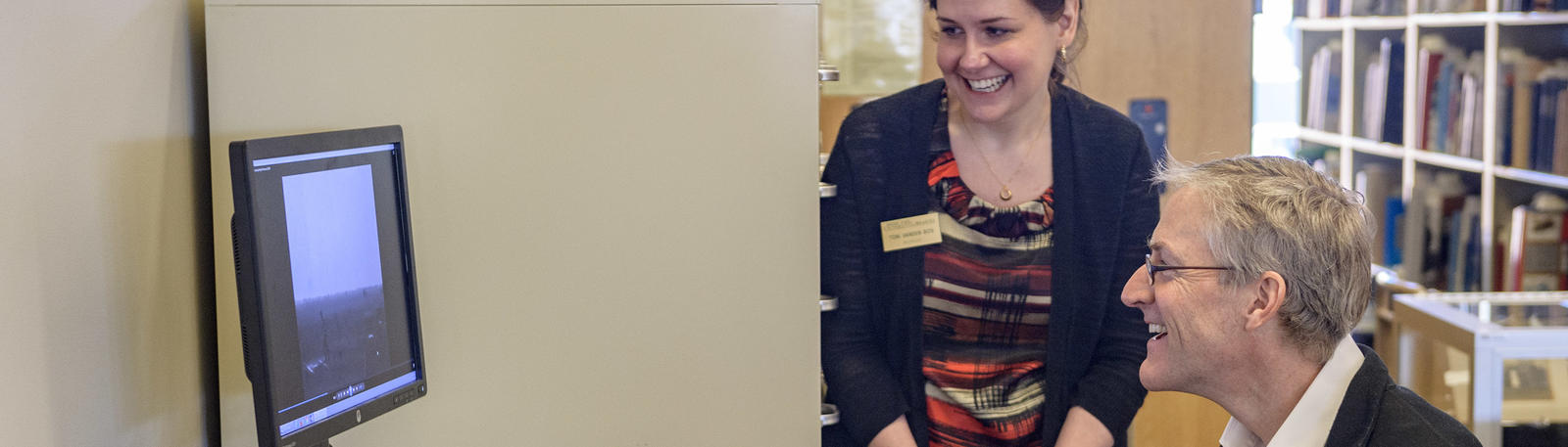 photo of a visitor and staff member in the archives