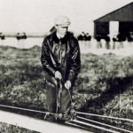 Wilbur Wright working on the launch rail ropes
