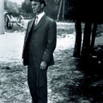 Wilbur Wright wearing his famous cap, standing, facing to his right at Le Mans, France