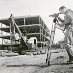 Original DDN caption (Oct. 13, 1963): "Dayton Campus: Airway Rd. Robert Eisenlohr Jr eng. surveys while building goes up in background."