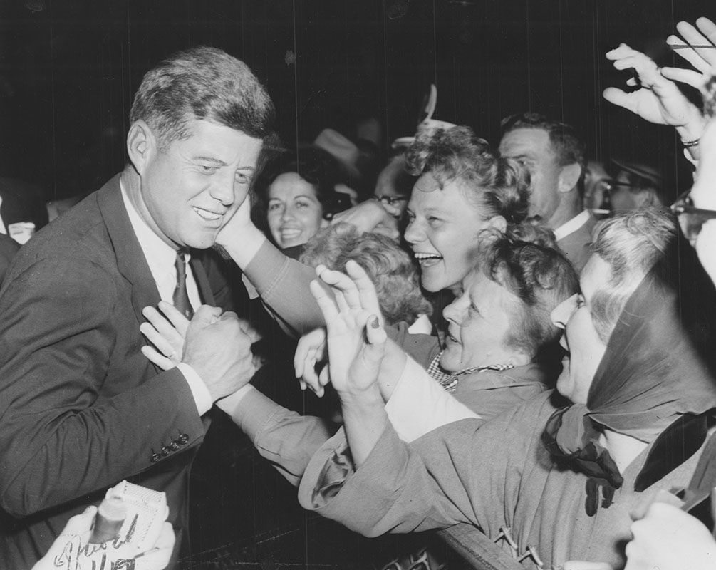 Women greeting Kennedy at the airport (Oct. 1960)