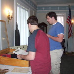 Arranging original materials in a tabletop exhibit case