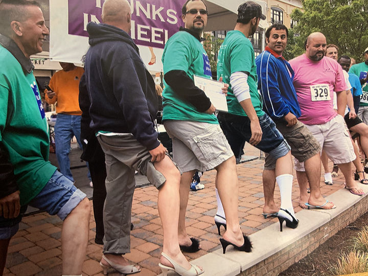 Men showing off their legs for the Hunks in Heels best leg contest (MS-628, Box 2, File 7)